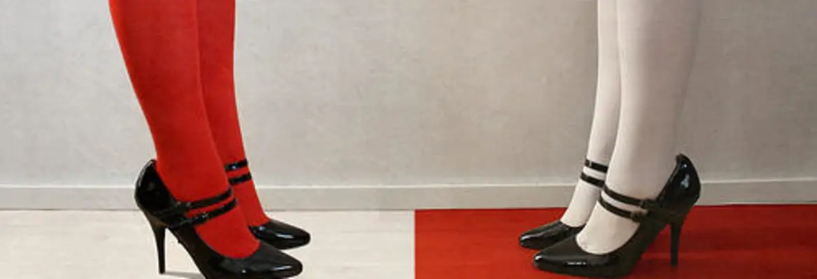 A split image showing two pairs of legs: one pair in red tights with black heels, and the other in white tights with black heels, positioned on contrasting colored floors.