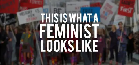 A group of diverse individuals marching in a protest, holding signs advocating for feminism and equal rights, with a focus on empowerment and solidarity.