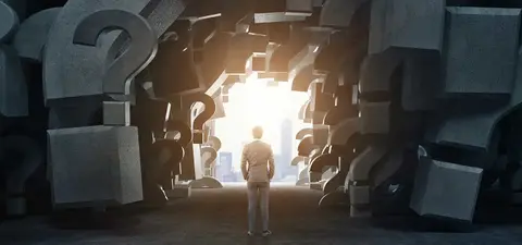 A person stands before a passage framed by large, abstract question marks, leading to a bright light, symbolizing curiosity and the pursuit of knowledge.