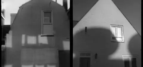 A diptych of two monochrome images of houses, showcasing contrasting shadows and lighting on their facades.