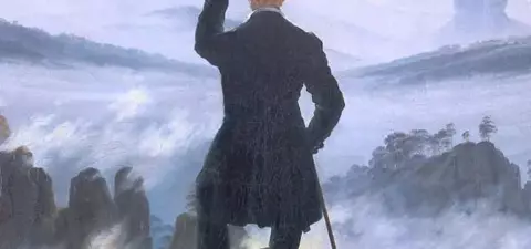 A figure in 19th-century clothing stands on a rocky outcrop, holding a smartphone, overlooking a misty valley with mountains in the background.