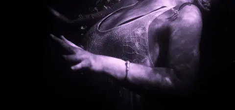 A submerged figure in a flowing dress, with a hand reaching out, surrounded by dark, murky water creating a mysterious, ethereal atmosphere.