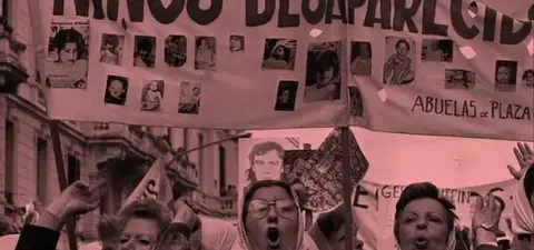 A historic protest by the Abuelas de Plaza de Mayo, featuring banners demanding justice for disappeared children during Argentina's military dictatorship, with women wearing headscarves and holding photos.
