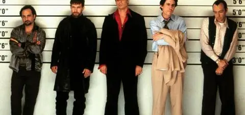 A lineup of five men standing against a height chart, each with distinct clothing and postures, portraying a scene reminiscent of a crime drama or thriller.