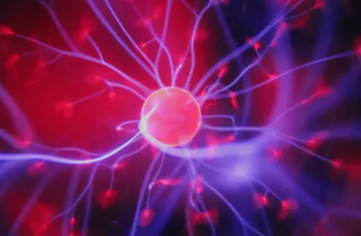 A vibrant plasma ball with glowing filaments of light radiating from a central orb, creating a dynamic and colorful electric effect.