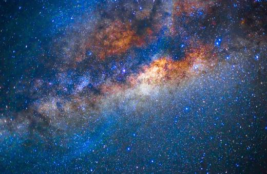 A stunning view of a galaxy featuring vibrant colors, swirling stars, and cosmic dust, showcasing the beauty of deep space.