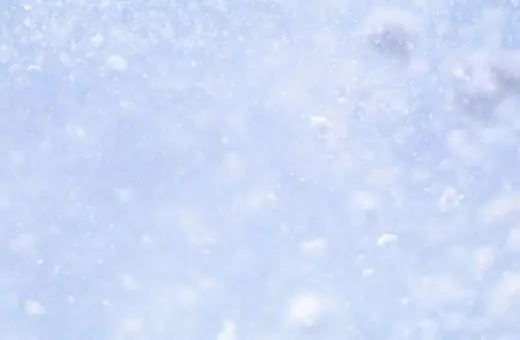 A close-up view of bubbles rising in clear water, creating a sense of movement and light, with a soft blue background.