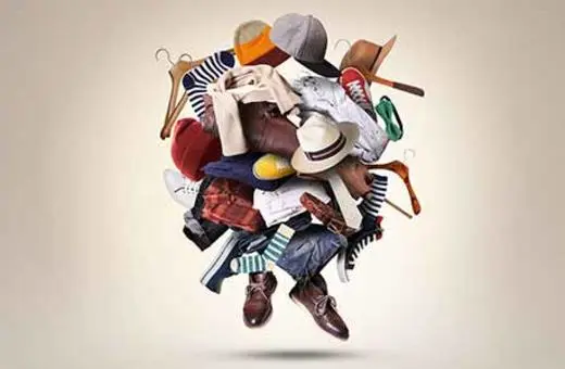 A colorful assortment of clothing, shoes, and accessories is depicted in a chaotic arrangement, creating a visually dynamic and playful composition.