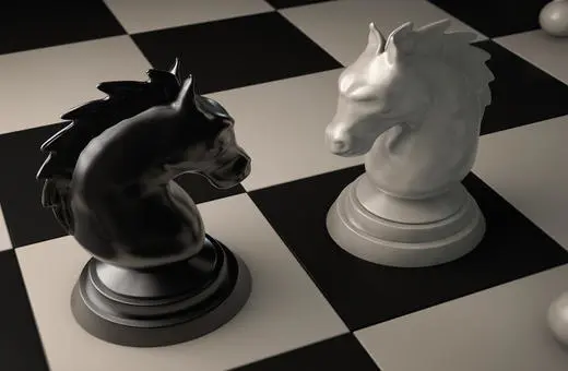 Two chess knights, one black and one white, face each other on a checkerboard pattern, with additional pieces visible in the background.