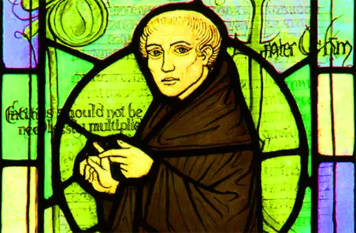 Stained glass depiction of a medieval scholar in robes, possibly reflecting themes of philosophy and theology. Notable figures in this context include Peter Abelard.