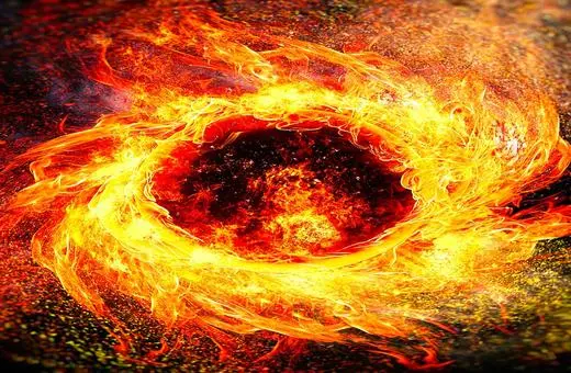 A swirling vortex of flames and energy, with a central dark core surrounded by vibrant orange and yellow fire patterns and sparks.