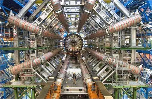 The interior view of the Large Hadron Collider, showcasing its complex array of tubes and machinery within a large underground facility.