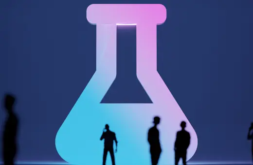 Silhouettes of people stand in front of a large, illuminated beaker symbol, blending shades of pink and blue against a dark background.