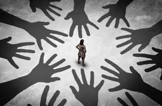 A lone figure stands amidst large shadows of hands reaching out, symbolizing themes of vulnerability and pressure.