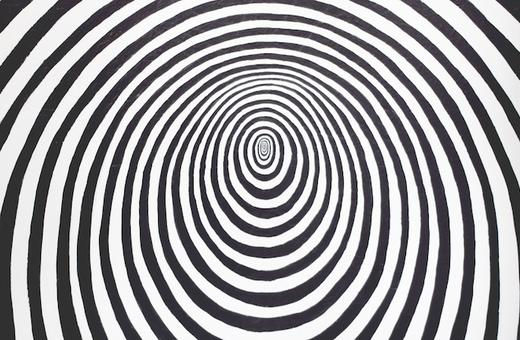 A pattern of concentric black and white stripes forming an optical illusion, creating a swirling, hypnotic effect toward the center.