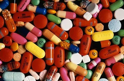 A colorful assortment of various pharmaceutical pills and capsules scattered across a surface.